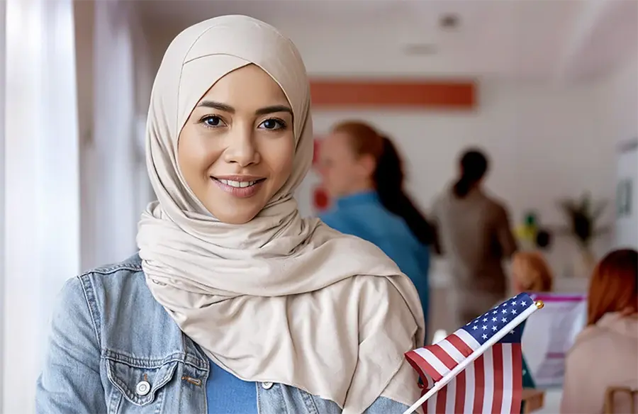 International students smiling and holding USA flag